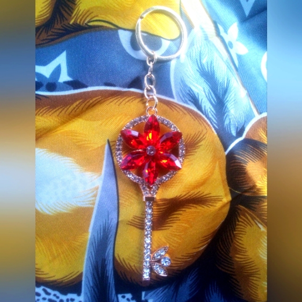 Gold keychain with red rhinestone